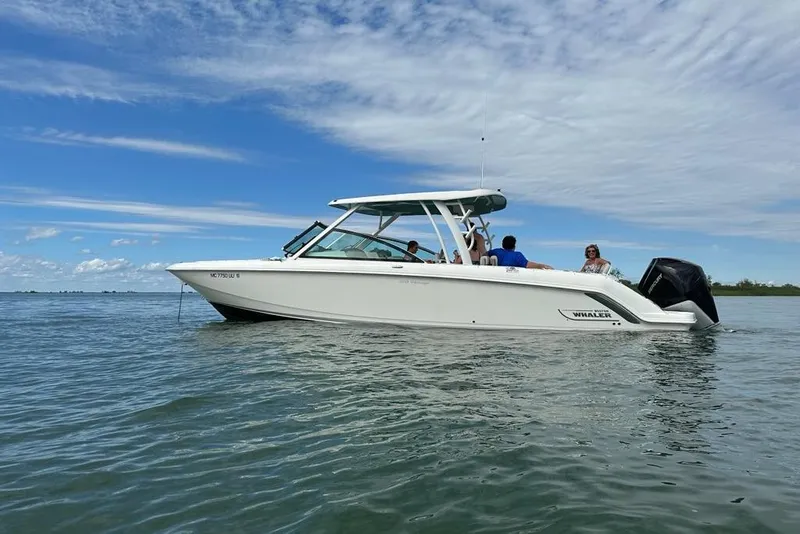 The Image of 2022 Boston Whaler 320 Vantage boat on calm water under a blue sky. - 0