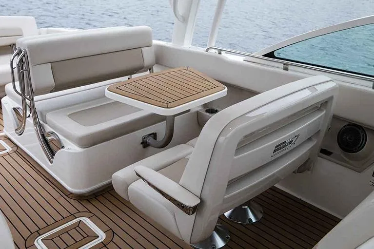 Slide: The Image of Manufacturer Provided Image: 2022 Boston Whaler 320 Vantage boat interior with seating and table. - 12