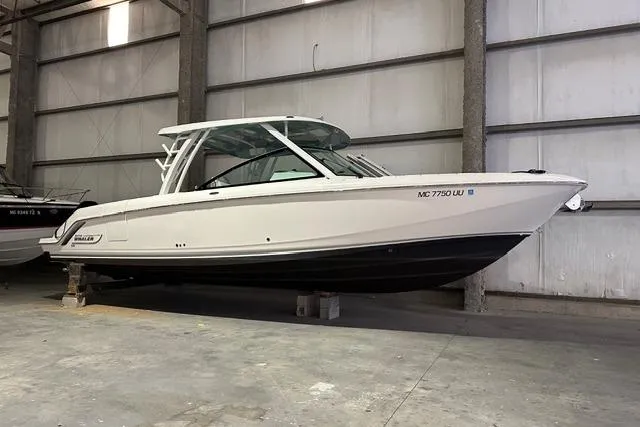 Slide: The Image of 2022 Boston Whaler 320 Vantage boat in a warehouse setting. - 4