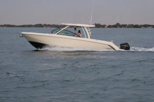 Slide: The Image of 2022 Boston Whaler 320 Vantage cruising on open water. - 8