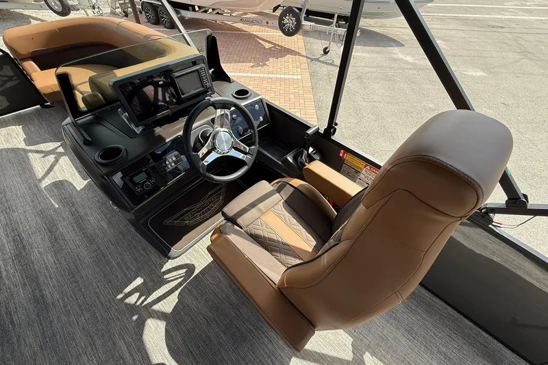 Slide: The Image of 2026 Bennington 24 M Fish and Cruise boat interior with steering wheel and seating. - 10