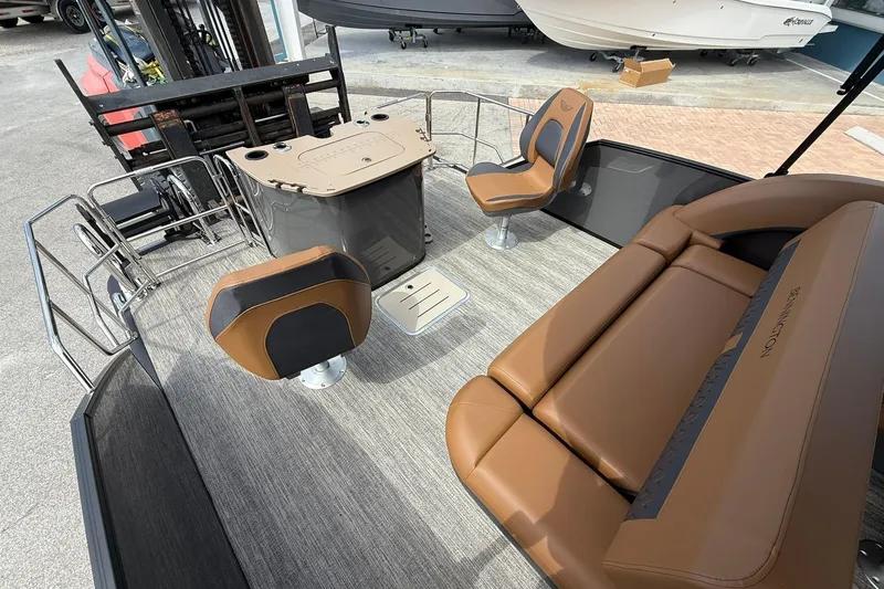 Slide: The Image of 2026 Bennington 24 M Fish and Cruise boat interior with brown seating and fishing station. - 5
