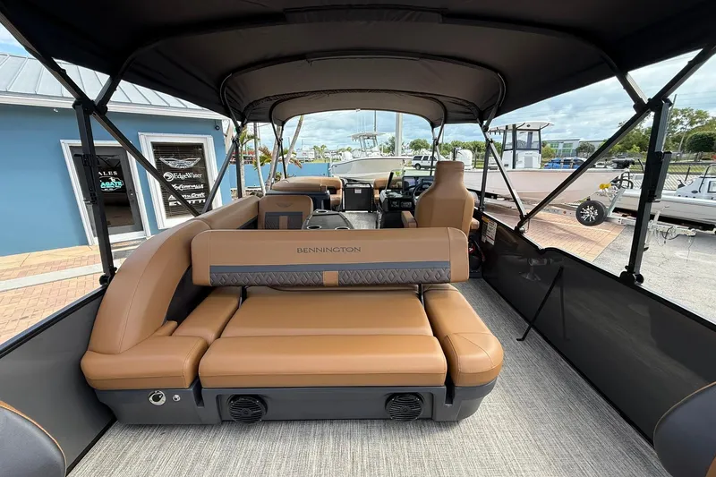 Slide: The Image of 2026 Bennington 24 M Fish and Cruise boat interior with tan seating and canopy. - 6