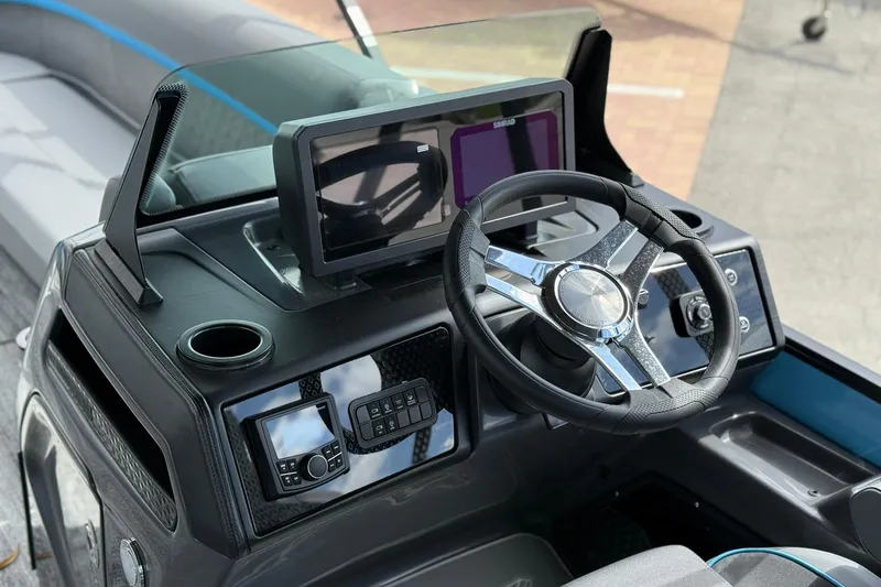 Slide: The Image of Steering console of 2026 Bennington 26 M Quad Bench boat with modern controls and display. - 9