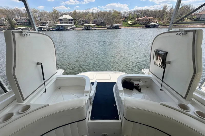 Slide: The Image of Open storage compartments on a 2003 Cobalt 282 boat, overlooking a scenic lakeside view. - 11