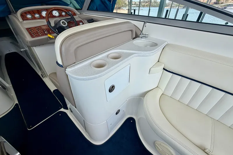 Slide: The Image of Interior of a 2003 Cobalt 282 boat featuring a steering wheel and seating area. - 14