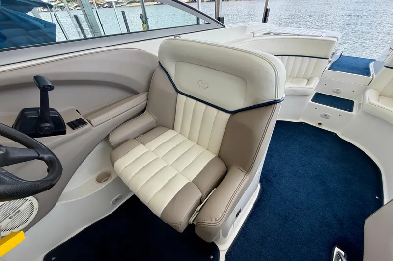 Slide: The Image of Interior of 2003 Cobalt 282 boat with plush seating and steering controls. - 15
