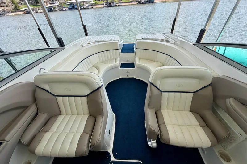 Slide: The Image of Interior of a 2003 Cobalt 282 boat with plush seating and blue carpet. - 17
