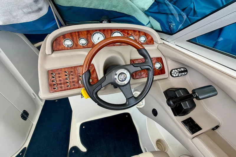 Slide: The Image of Steering console of a 2003 Cobalt 282 boat with wood accents and gauges. - 18