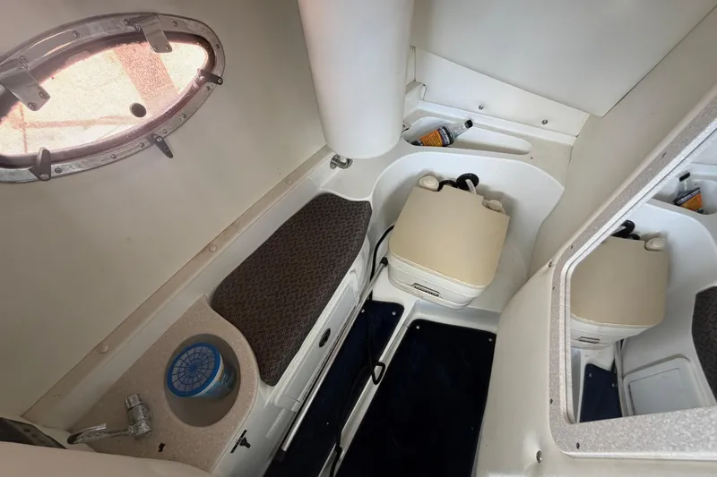 Slide: The Image of Interior cabin of a 2003 Cobalt 282 boat with seating and a small sink. - 20