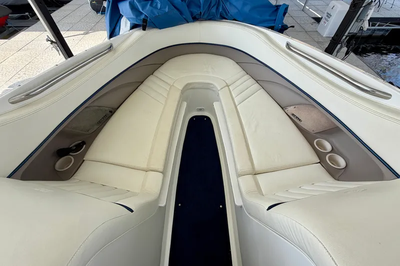 Slide: The Image of Interior of a 2003 Cobalt 282 boat with white seating and cup holders. - 21