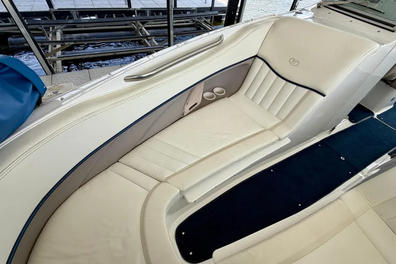 Slide: The Image of Luxurious seating on a 2003 Cobalt 282 boat, featuring white upholstery and cup holders. - 22