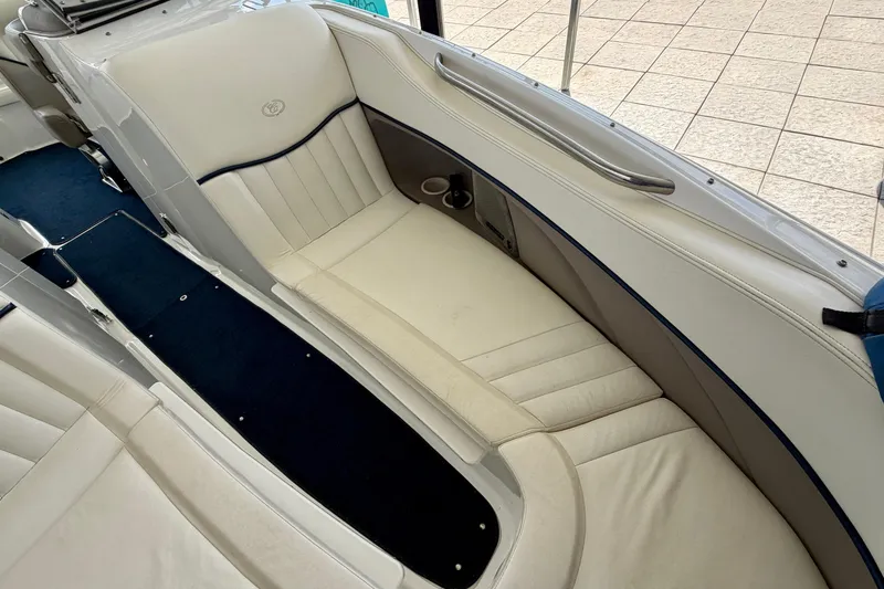 Slide: The Image of Interior seating of a 2003 Cobalt 282 boat with white upholstery and blue accents. - 23