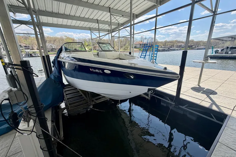 Slide: The Image of 2003 Cobalt 282 boat docked in a marina under a covered structure. - 4
