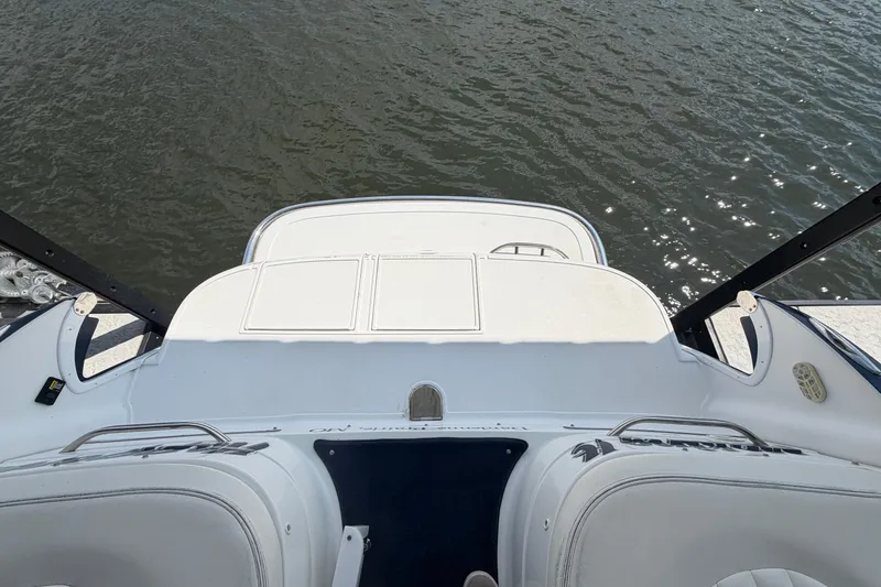 Slide: The Image of Rear view of a 2003 Cobalt 282 boat with white seating and water backdrop. - 6