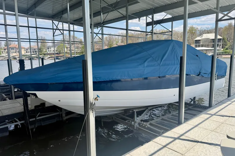 Slide: The Image of 2003 Cobalt 282 boat covered with blue tarp in a marina dock. - 7