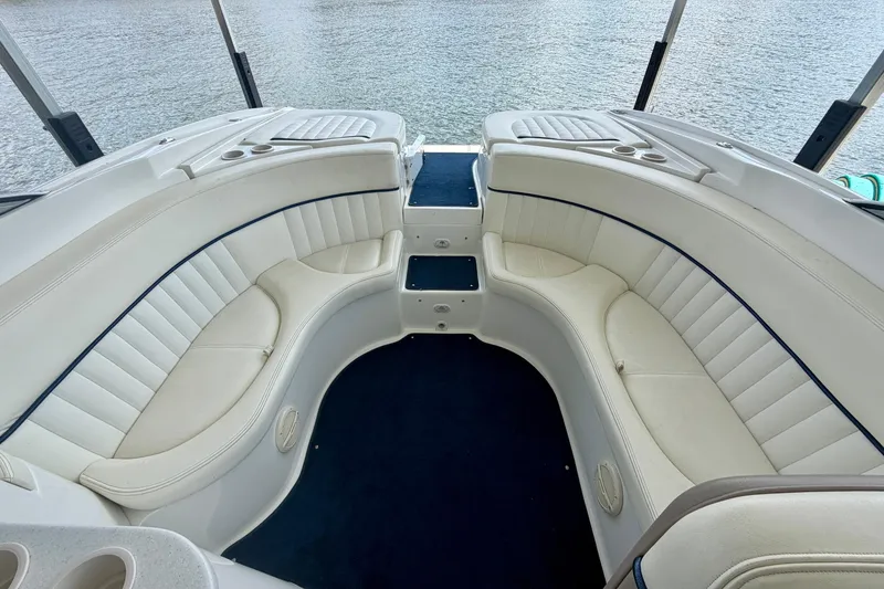 Slide: The Image of Luxurious interior of a 2003 Cobalt 282 boat with white seating and blue accents. - 8