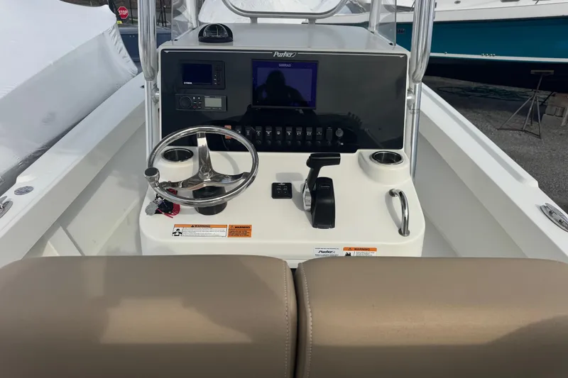Slide: The Image of 2019 Parker 23 Special Edition boat console with steering wheel and navigation controls. - 2
