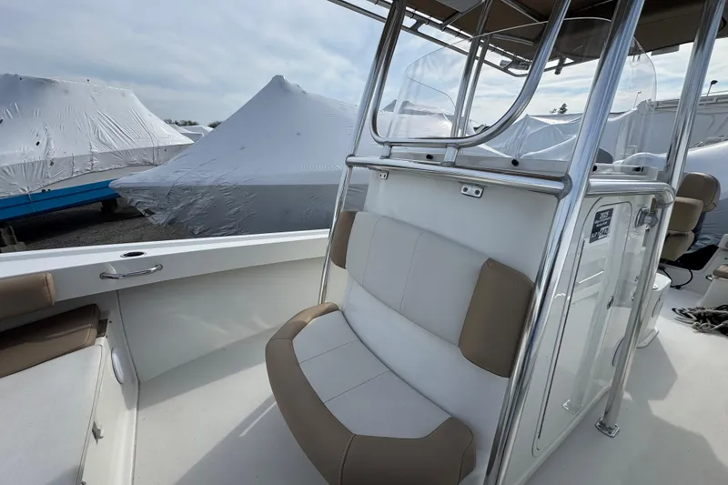 Slide: The Image of 2019 Parker 23 Special Edition boat interior with seating and covered boats in background. - 4