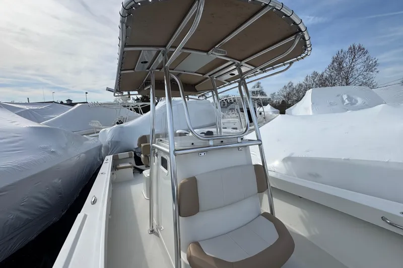 Slide: The Image of 2019 Parker 23 Special Edition boat with T-top, docked among covered vessels. - 6