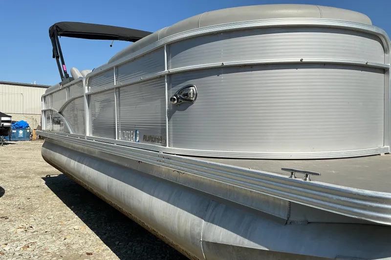 Slide: The Image of 2018 Manitou 23 Aurora LE RF pontoon boat with canopy, parked outdoors. - 4