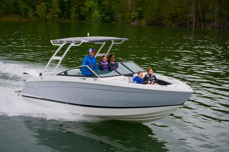 The Image of 2026 Cobalt R6 Outboard boat cruising on a lake with passengers enjoying the ride. - 0