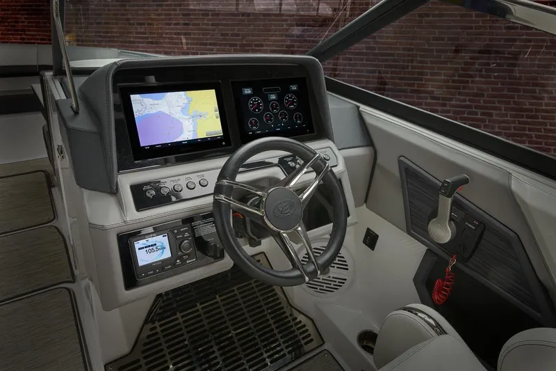Slide: The Image of 2026 Cobalt R6 Outboard boat dashboard with navigation screens and steering wheel. - 10