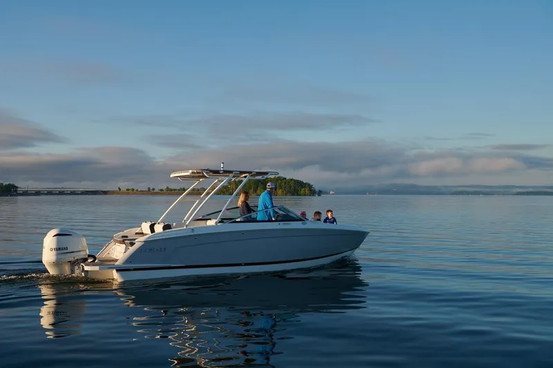 Slide: The Image of 2026 Cobalt R6 Outboard boat cruising on a calm lake at sunrise. - 13