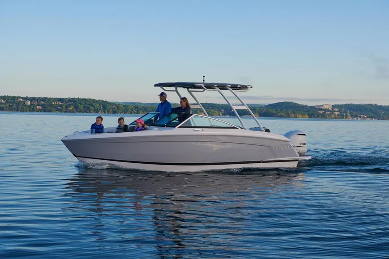 Slide: The Image of 2026 Cobalt R6 Outboard boat cruising on a serene lake with passengers onboard. - 14