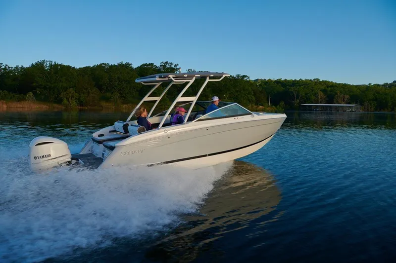 Slide: The Image of 2026 Cobalt R6 Outboard boat cruising on a serene lake at sunset. - 2