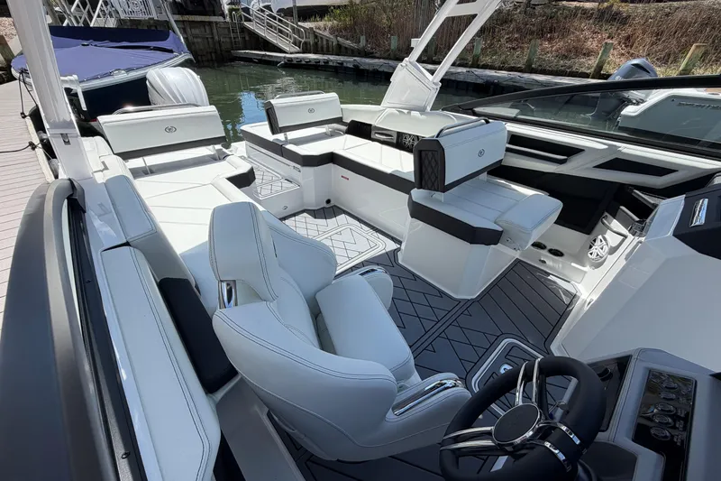 Slide: The Image of 2026 Cobalt R6 Outboard boat interior with white captain's chair and modern dashboard. - 25