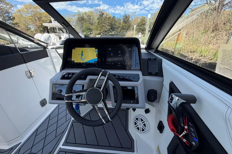 Slide: The Image of 2026 Cobalt R6 Outboard boat docked in a serene marina setting. - 26