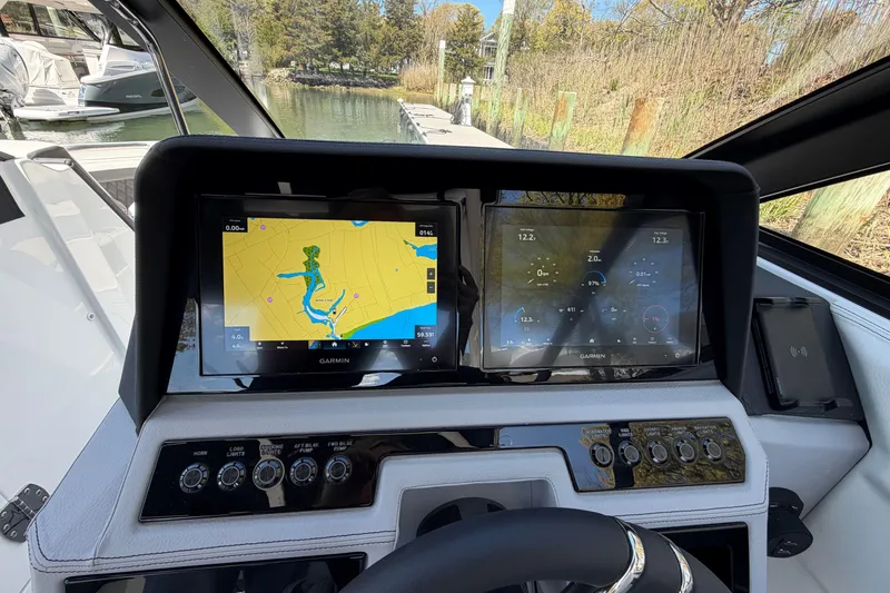 Slide: The Image of Open anchor compartment on 2026 Cobalt R6 Outboard boat, docked by the water. - 28