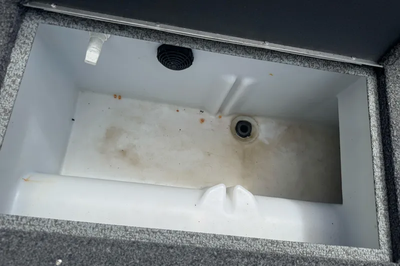 Slide: The Image of 2019 Lund 1675 Adventure Sport boat compartment, featuring a drain and textured interior. - 10