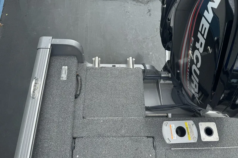 Slide: The Image of 2019 Lund 1675 Adventure Sport boat with Mercury engine, featuring carpeted deck and storage compartments. - 11