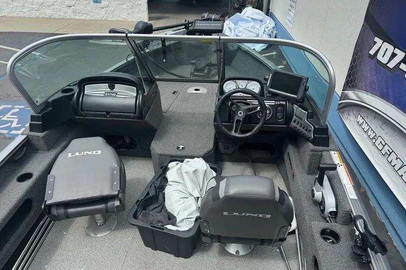 Slide: The Image of 2019 Lund 1675 Adventure Sport boat interior with steering console and seating. - 12