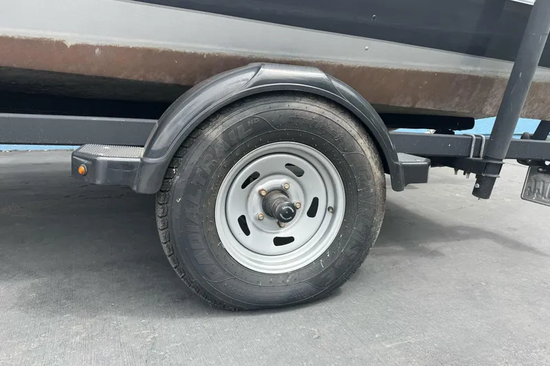 Slide: The Image of Trailer wheel of 2019 Lund 1675 Adventure Sport boat on pavement. - 3