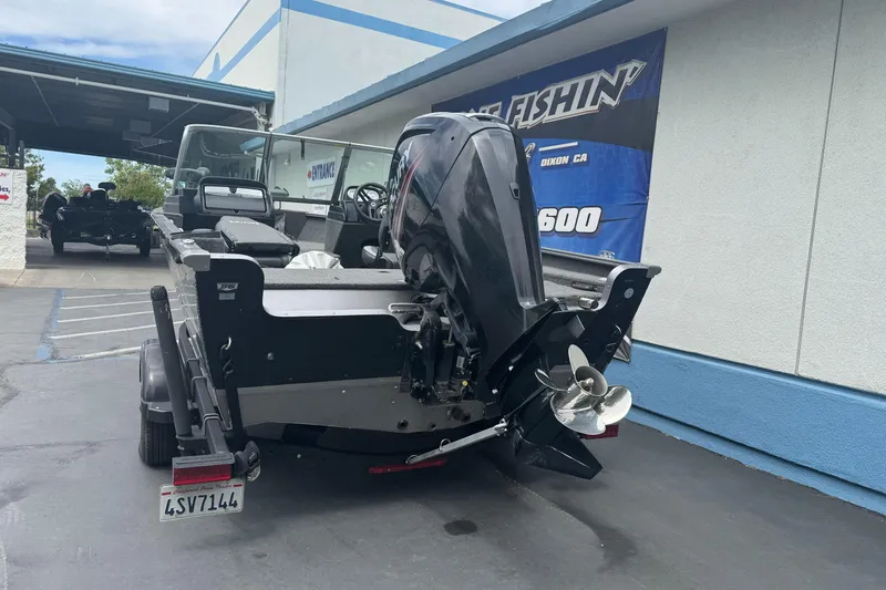 Slide: The Image of 2019 Lund 1675 Adventure Sport boat with outboard motor in a parking lot. - 4