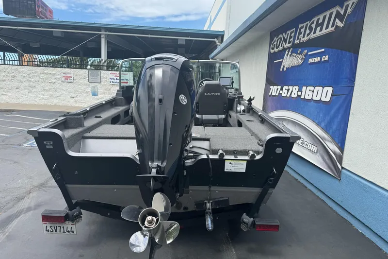 Slide: The Image of 2019 Lund 1675 Adventure Sport boat with outboard motor, parked outside a dealership. - 5