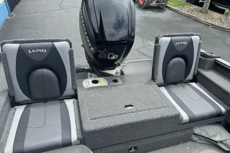 Slide: The Image of 2019 Lund 1675 Adventure Sport boat seats with Mercury engine in background. - 9