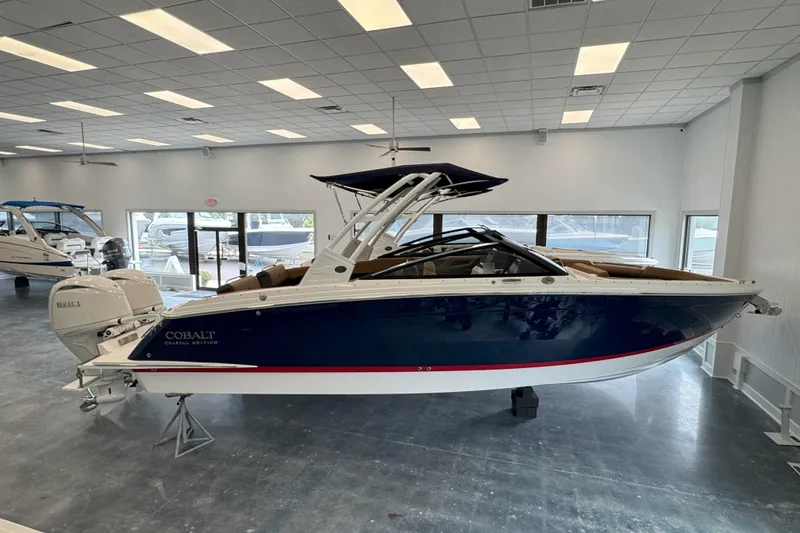 The Image of 2025 Cobalt R8 Outboard boat in showroom, blue hull, white interior, Yamaha engine. - 0
