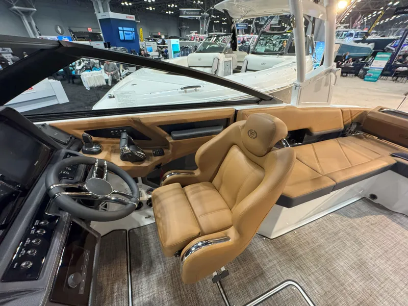Slide: The Image of 2025 Cobalt R8 Outboard boat interior with luxurious tan seating and modern dashboard. - 16