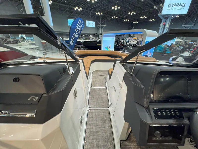 Slide: The Image of 2025 Cobalt R8 Outboard interior at a boat show, featuring modern design and controls. - 19