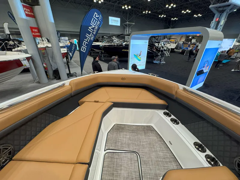 Slide: The Image of 2025 Cobalt R8 Outboard interior at a boat show, featuring tan seating and modern design. - 20