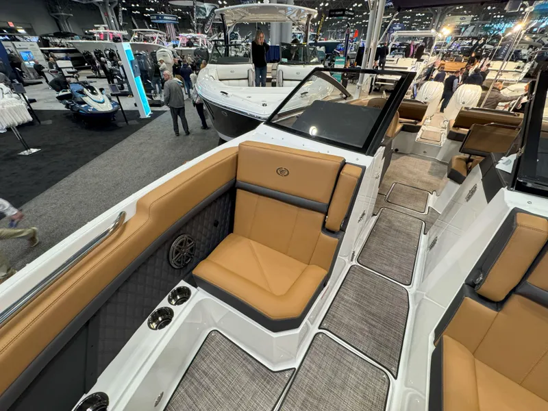 Slide: The Image of 2025 Cobalt R8 Outboard boat interior with tan seating at a boat show. - 22