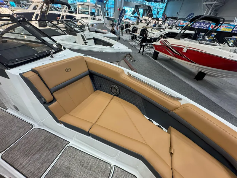 Slide: The Image of 2025 Cobalt R8 Outboard boat interior with tan seating at a boat show. - 24
