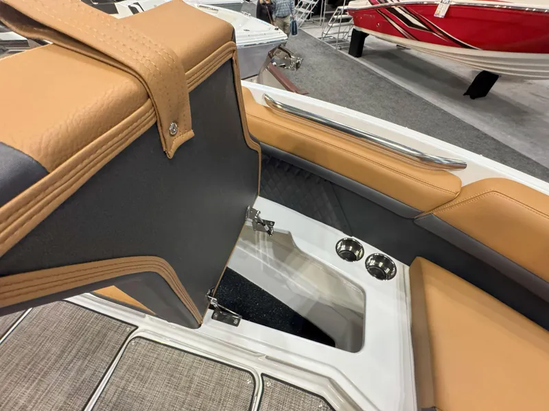 Slide: The Image of 2025 Cobalt R8 Outboard boat interior with tan and gray seating, storage, and cup holders. - 25