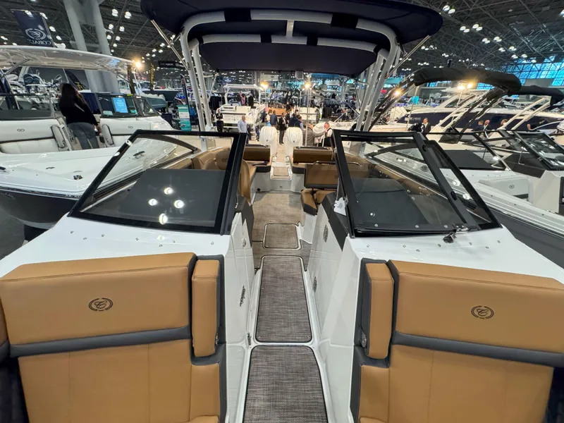 Slide: The Image of 2025 Cobalt R8 Outboard boat interior at a boat show, featuring luxurious seating and modern design. - 26