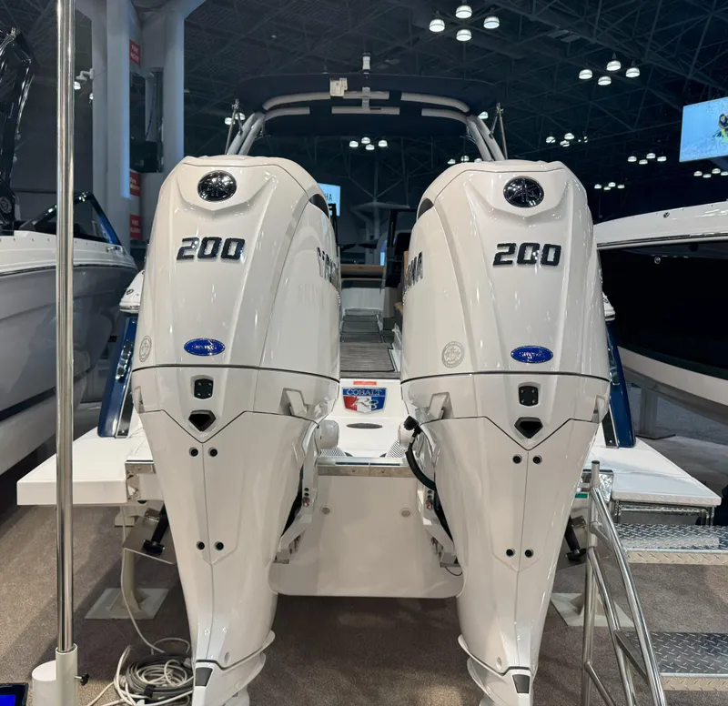 Slide: The Image of 2025 Cobalt R8 Outboard with dual 200 horsepower engines displayed indoors. - 3