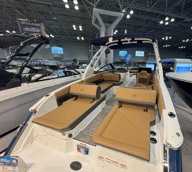 Slide: The Image of 2025 Cobalt R8 Outboard boat interior with tan seating at a boat show. - 4